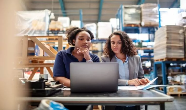 project manager working at computer in factory