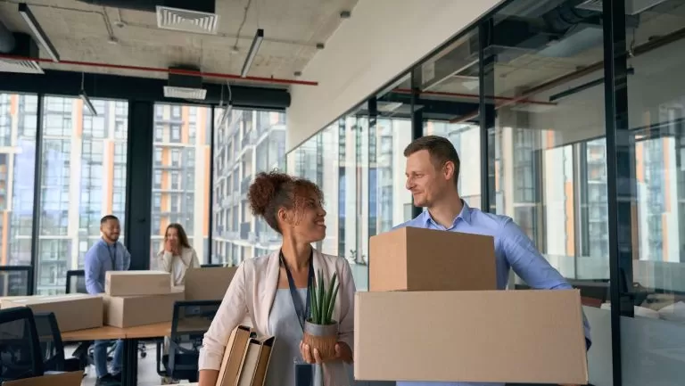 Happy corporate workers preparing for commercial moving service